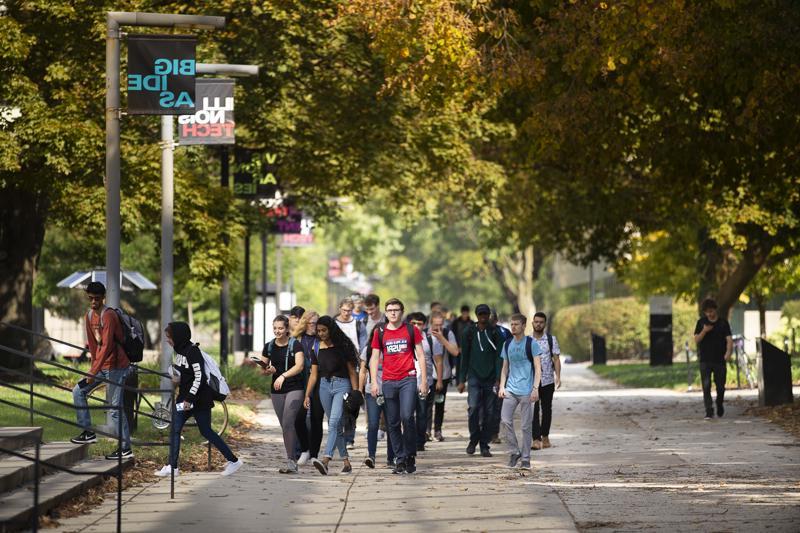 Students walk to class down the main stretch of campus