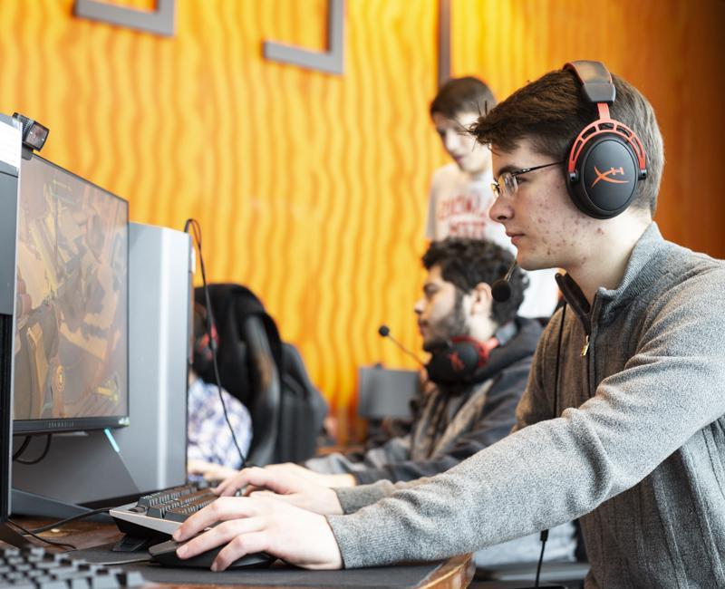 A student plays a video game in the Esports lab